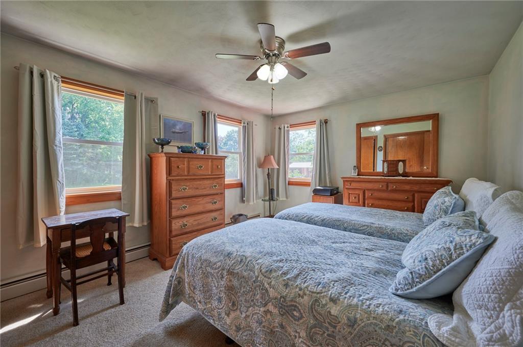 2583 Highway 210 Rural Valley, PA 16249 - Photo 15 of 41 a bedroom with a large bed and a chandelier
