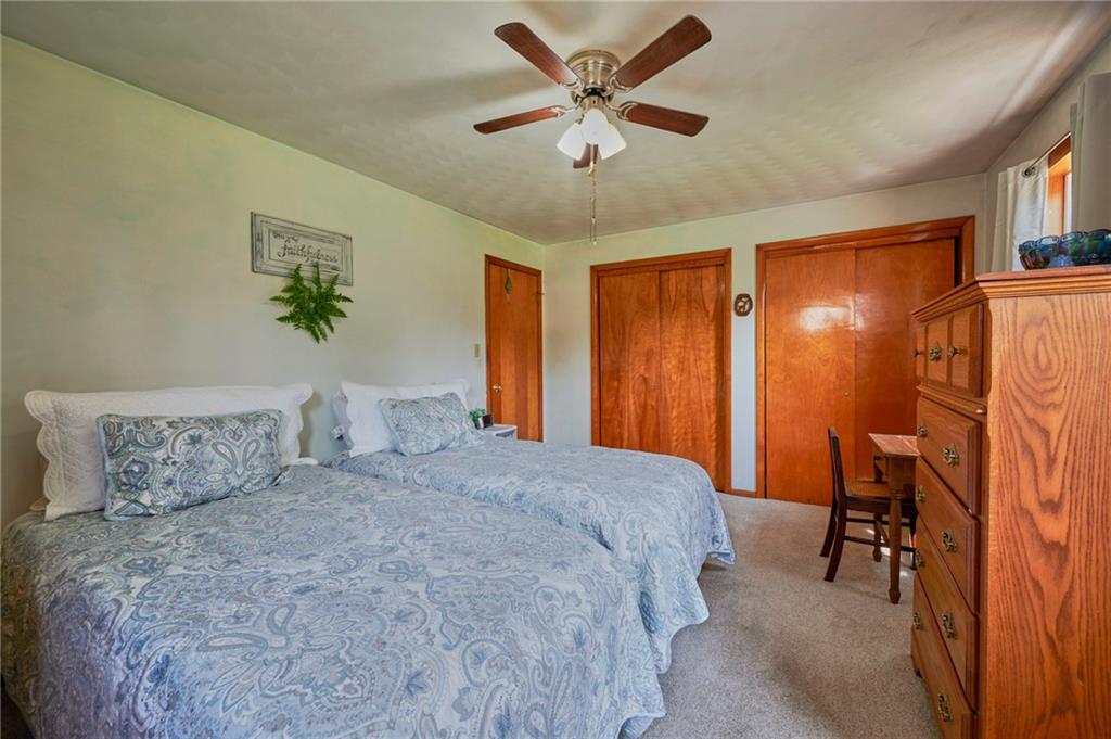 2583 Highway 210 Rural Valley, PA 16249 - Photo 16 of 41 a bedroom with a bed and a chandelier