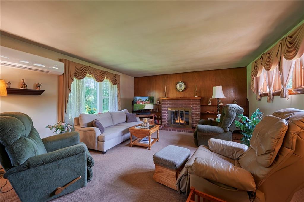 2583 Highway 210 Rural Valley, PA 16249 - Photo 4 of 41 a living room with furniture a fireplace and a large window