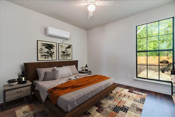 a bedroom with a bed and a large window