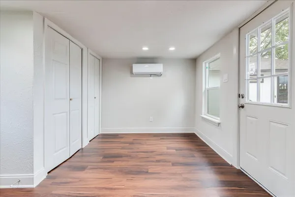 wooden floor in an empty room with a window