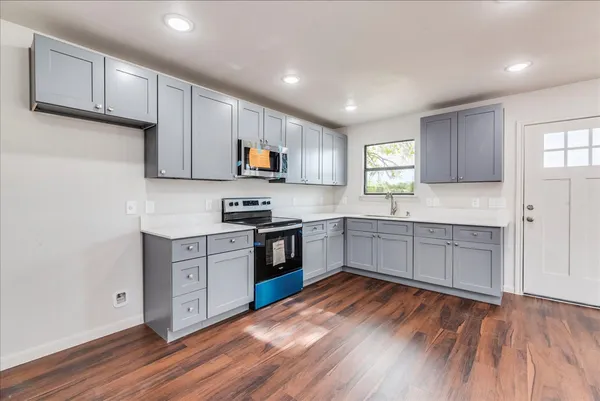 a kitchen with a white cabinets and appliances
