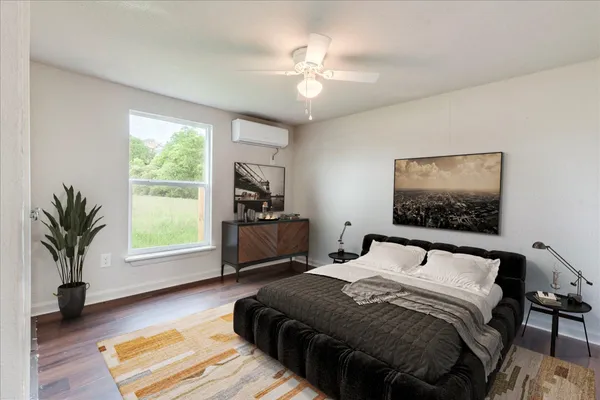 a bedroom with a large bed and a chandelier