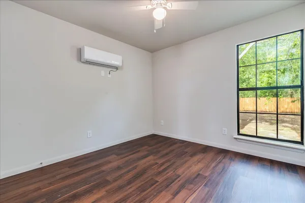 wooden floor in an empty room with a window