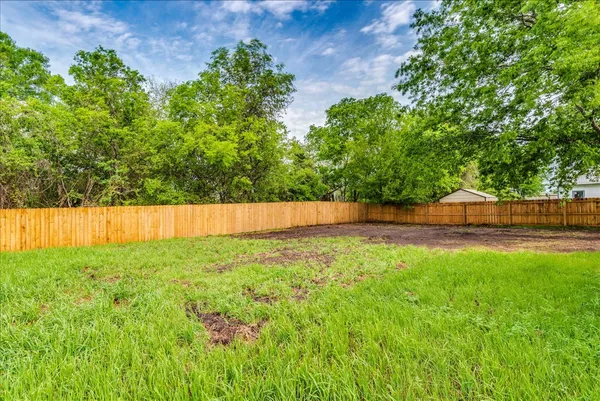 a backyard of a house with lots of green space