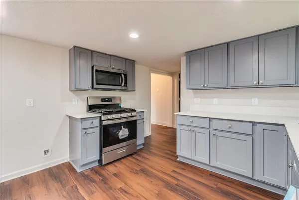 a kitchen with granite countertop a stove and a sink