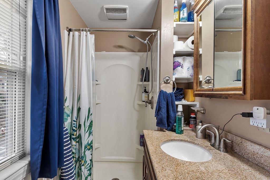 51 Crescent Street Wakefield, MA 01880 - Photo 14 of 20 a bathroom with a granite countertop sink and a mirror