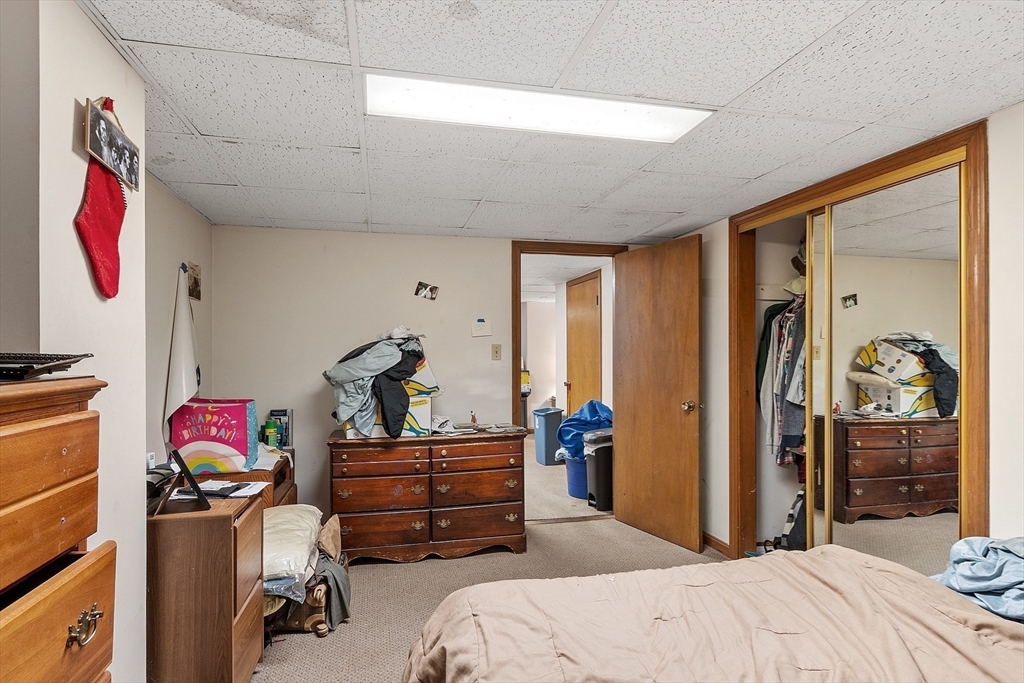 51 Crescent Street Wakefield, MA 01880 - Photo 18 of 20 a bedroom with a bed and wooden floor