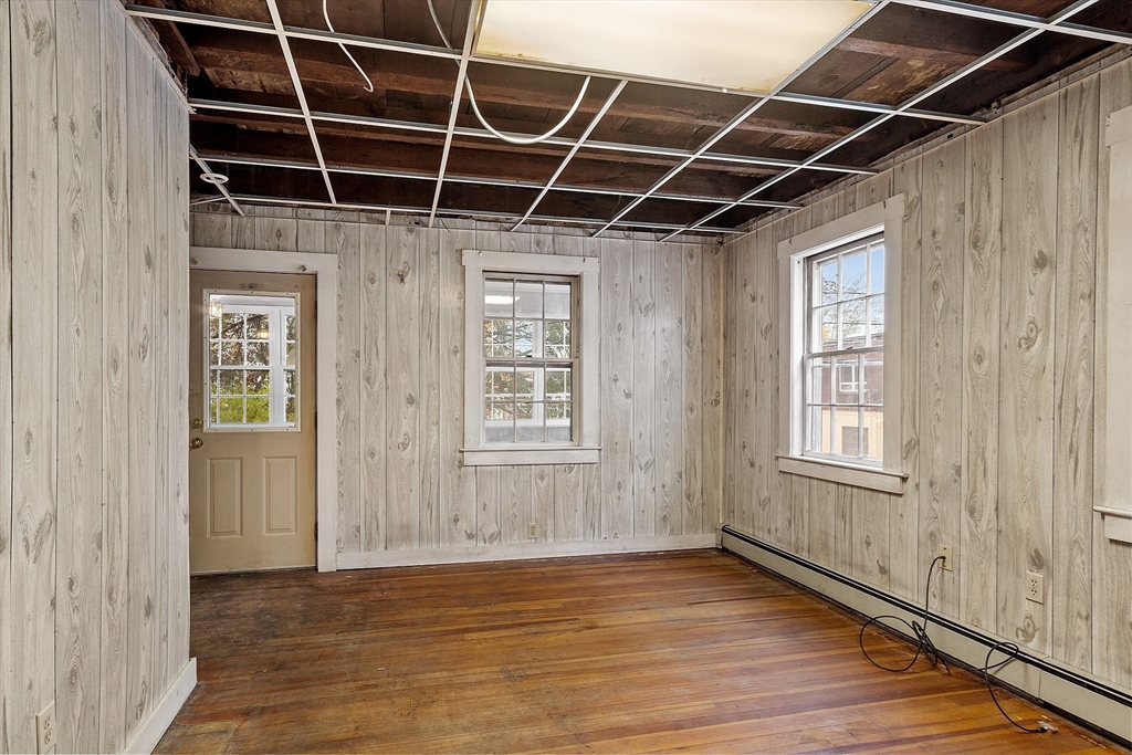 51 Crescent Street Wakefield, MA 01880 - Photo 3 of 20 a view of an empty room with wooden floor and windows