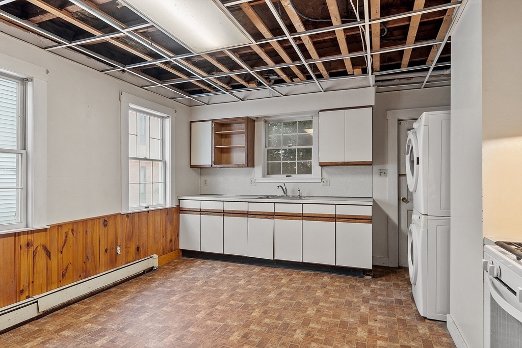 51 Crescent Street Wakefield, MA 01880 - Photo 7 of 20 a kitchen with stainless steel appliances granite countertop a sink and a refrigerator