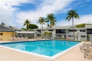 911 Northeast 199th Street, Unit 10414 Miami, FL 33179 - Photo 1 of 18 a view of a swimming pool with outdoor seating