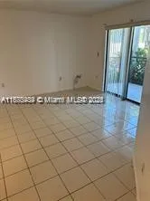 a view of a livingroom with an empty space and a window