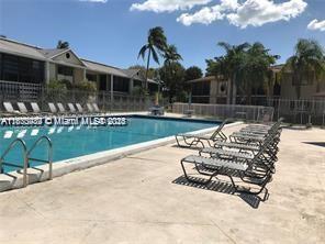 911 Northeast 199th Street, Unit 10414 Miami, FL 33179 - Photo 17 of 18 a view of a house with backyard porch and sitting area