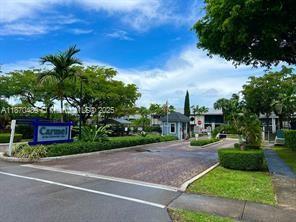 911 Northeast 199th Street, Unit 10414 Miami, FL 33179 - Photo 18 of 18 a view of a street with a building and a street sign