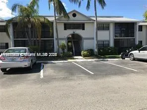 a view of a building with car parked