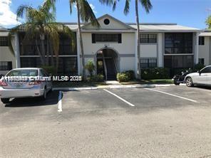 911 Northeast 199th Street, Unit 10414 Miami, FL 33179 - Photo 2 of 18 a view of a building with car parked