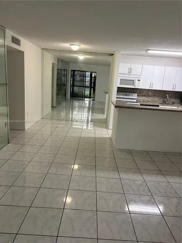 a kitchen with stainless steel appliances a sink and cabinets