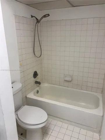 a bathroom with a toilet and a bath tub
