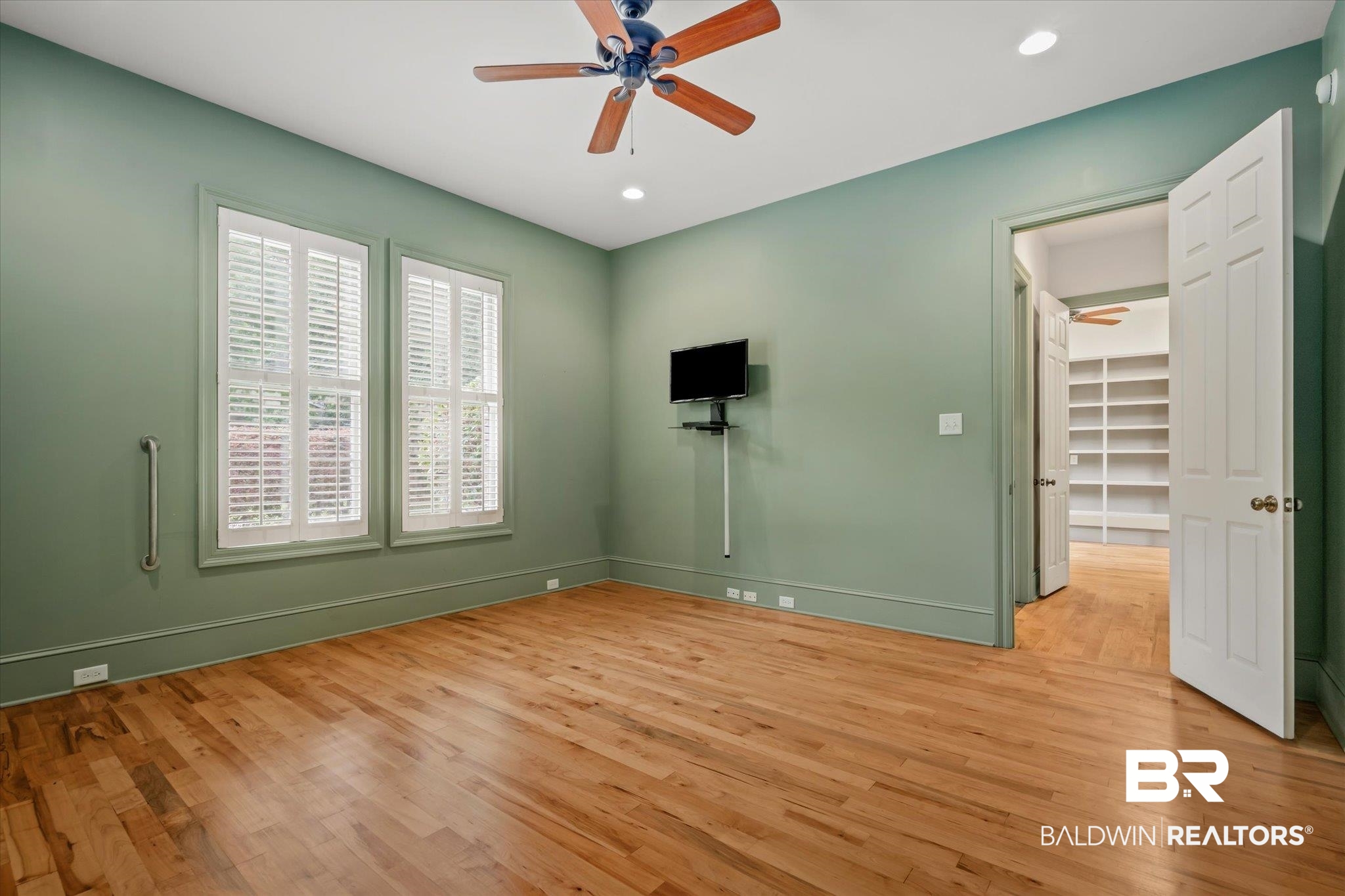 812 Country Club Court Mobile, AL 36609 - Photo 11 of 34 Unfurnished room featuring light hardwood / wood-style flooring and ceiling fan