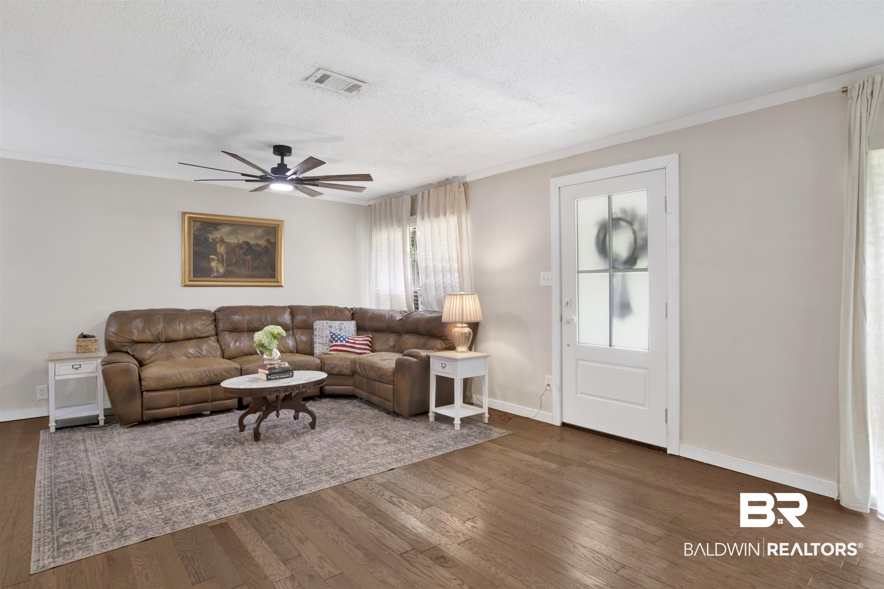 4265 Greaves Road Eight Mile, AL 36613 - Photo 7 of 34 Living area featuring dark wood-type flooring, a ceiling fan, and a textured ceiling
