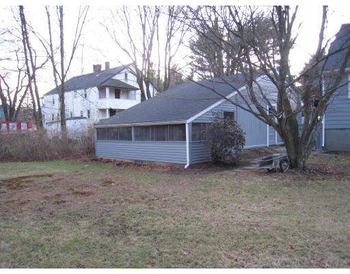 110 School Street Lexington, MA 02421 - Photo 3 of 15 a view of a house with a large tree and wooden fence