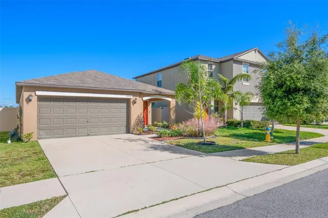 a front view of a house with a yard and garage