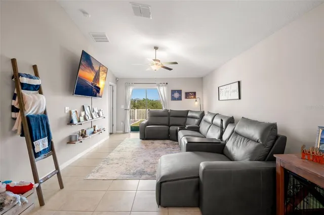 a living room with furniture a projector and a flat screen tv