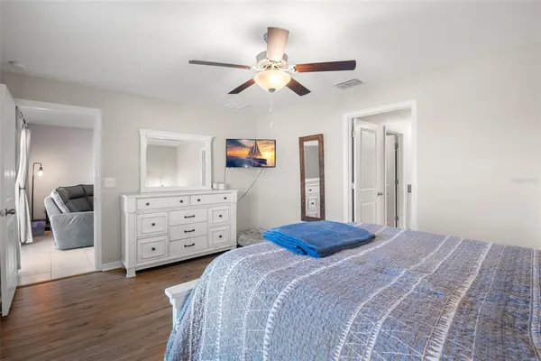 a bedroom with a bed and wooden floor