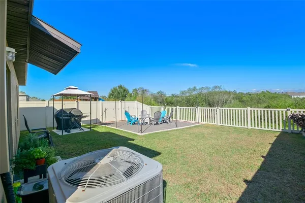 a view of a backyard with sitting area