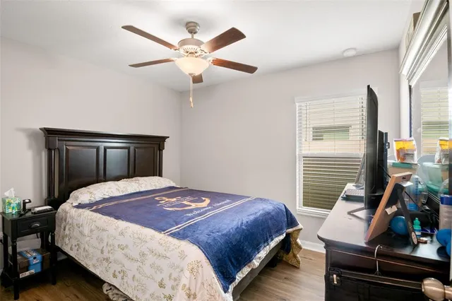 a bedroom with a bed and a chandelier
