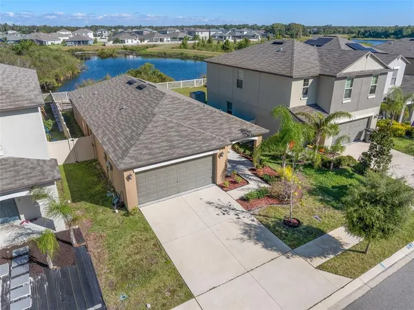 an aerial view of a house with a yard