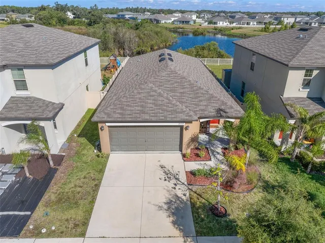 an aerial view of a house with yard