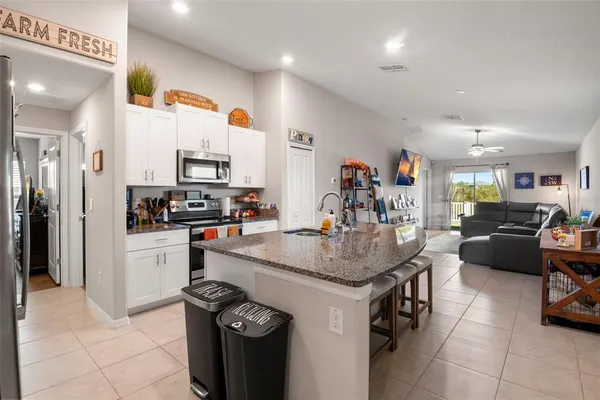 a kitchen with a sink a stove and cabinets