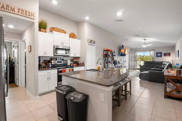 a kitchen with a sink a stove and cabinets