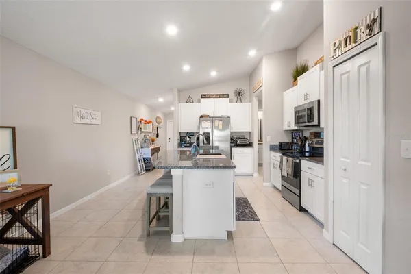 a kitchen with stainless steel appliances granite countertop a refrigerator and a sink