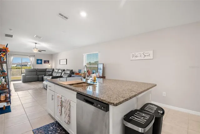 a kitchen with sink cabinets and stove
