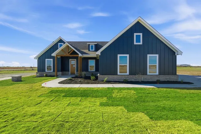 a front view of a house with swimming pool having outdoor seating
