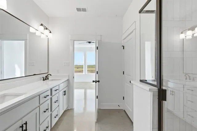 a bathroom with a double vanity sink and mirror