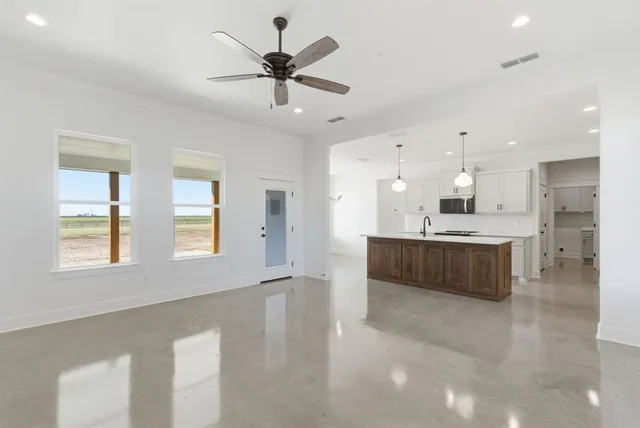a large white kitchen with a large window