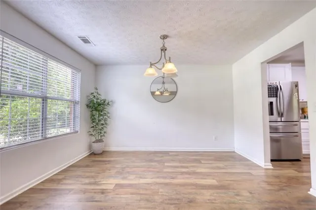 a kitchen with lots of clutter and cabinets