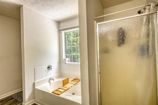 a spacious bedroom with a bed and a chandelier