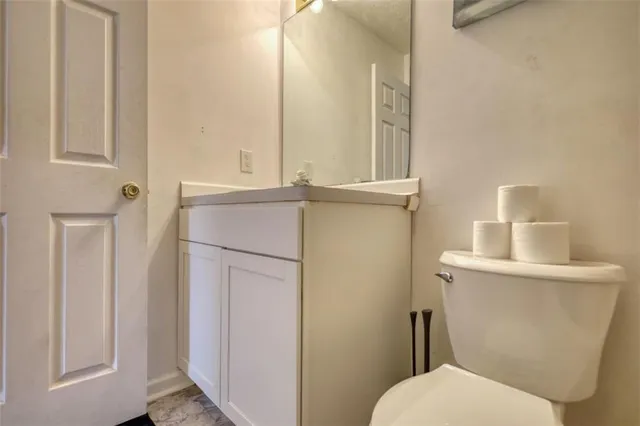 a patio with table and chairs and potted plants