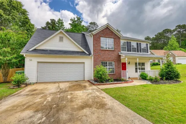 a front view of a house with a yard