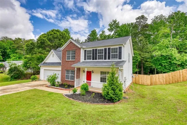 an aerial view of a house with a garden and trees