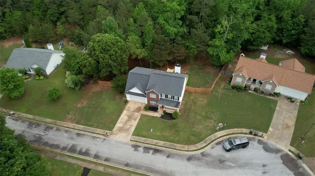 an aerial view of a house with outdoor space