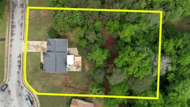 an aerial view of a house with garden space and street view