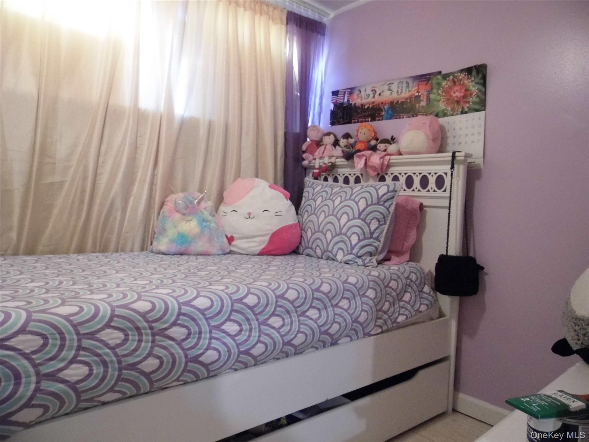 86-75 80th Street Queens, NY 11421 - Photo 11 of 20 a bedroom with a bed and a window