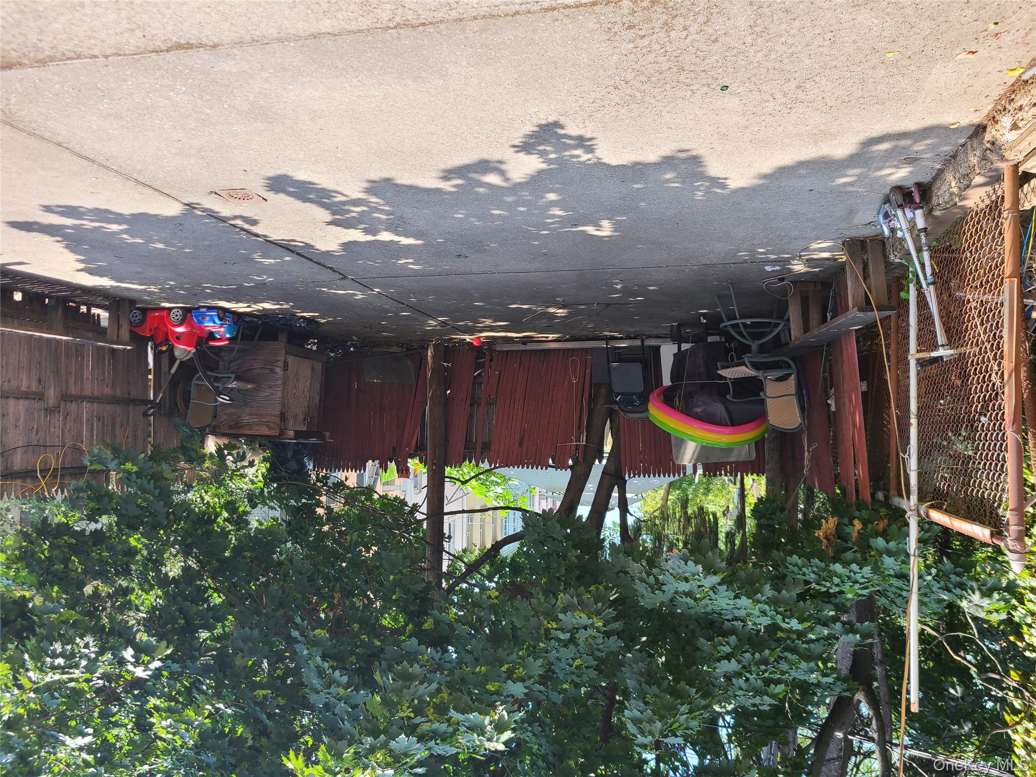 86-75 80th Street Queens, NY 11421 - Photo 20 of 20 a view of backyard with table and chairs and a large tree
