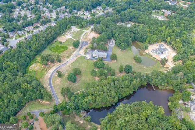 an aerial view of a houses with yard