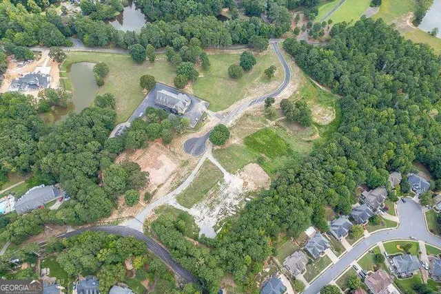 an aerial view of residential house with outdoor space and lake view